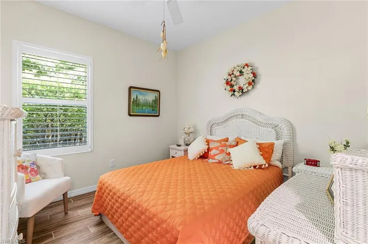 Bedroom with wood tiled floors and ceiling fan
