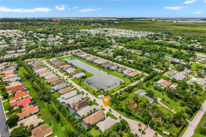 Aerial view of property and surrounding area with nearby suburban area