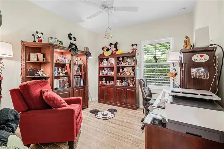 Office space with wood finish floors and a ceiling fan