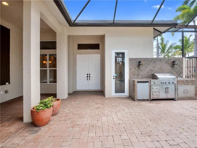 Doorway to property with a patio area