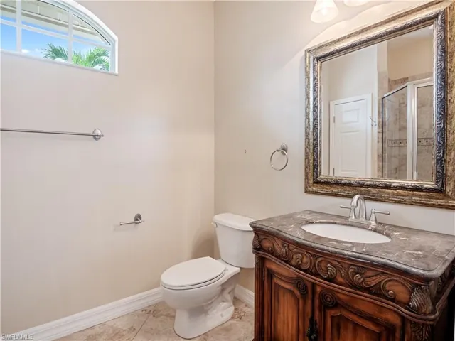 Bathroom featuring vanity, toilet, and tile patterned flooring