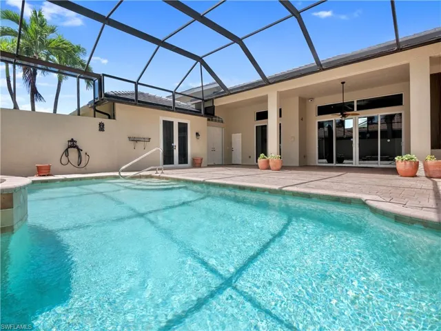 View of pool featuring a lanai, french doors, a patio, and ceiling fan