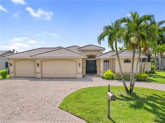 View of front of house with a garage and a front lawn