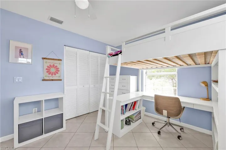 Tiled bedroom featuring baseboards, a closet, and a ceiling fan