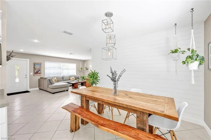 Dining space featuring baseboards, light tile patterned floors, and recessed lighting