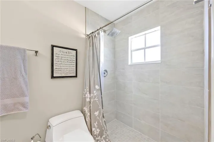 Bathroom with a tile shower and toilet