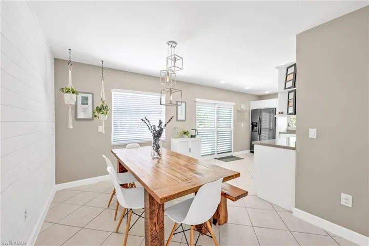 Dining room with light tile patterned floors and baseboards