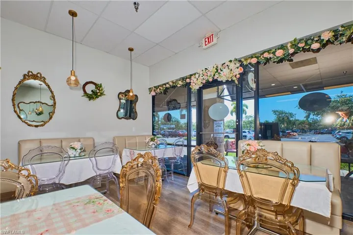 Dining space featuring a drop ceiling and wood finished floors