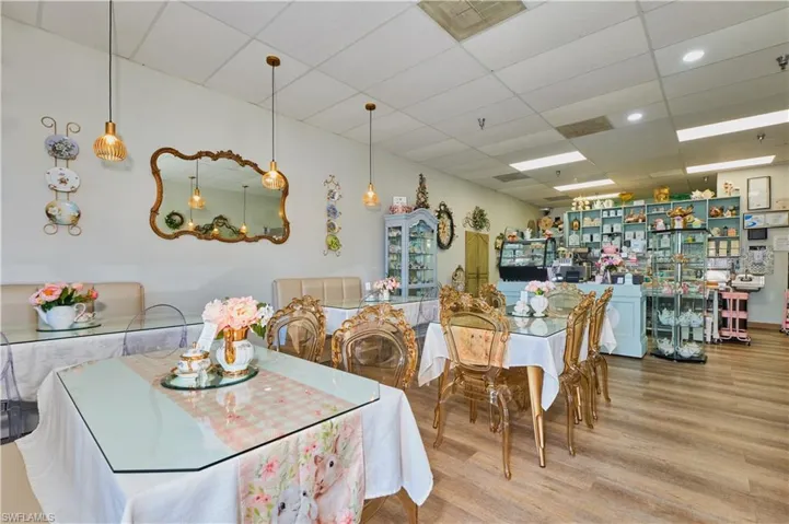 Dining space with wood finished floors and a drop ceiling