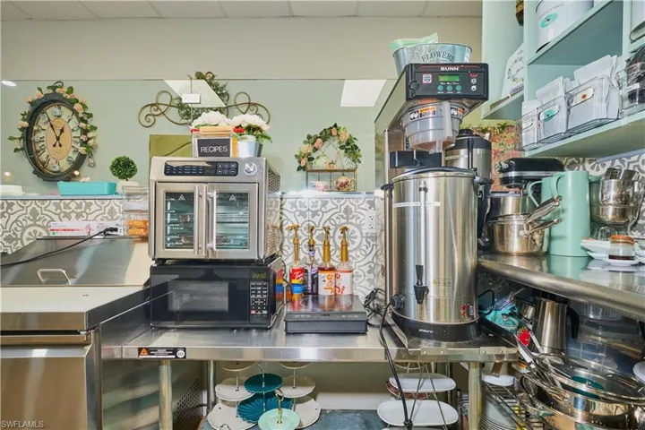 Kitchen featuring a drop ceiling and black microwave