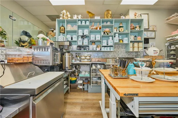 Kitchen with a paneled ceiling, butcher block counters, and wood finished floors