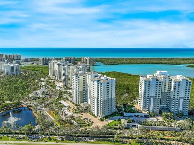 Birds eye view of property with a water view