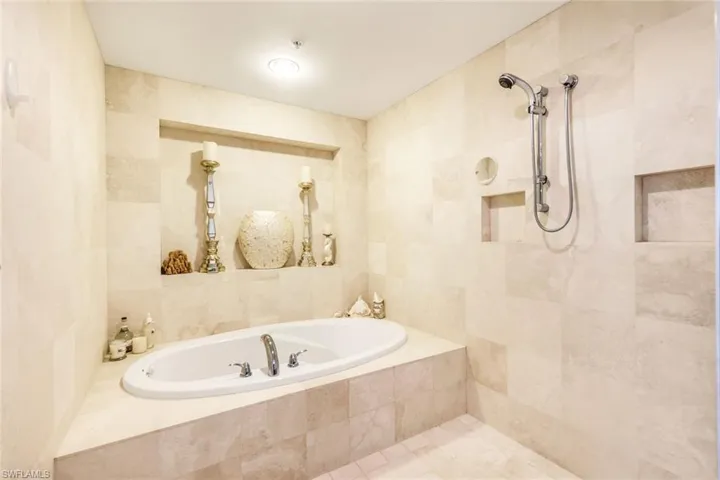 Bathroom with tile walls and a relaxing tiled bath