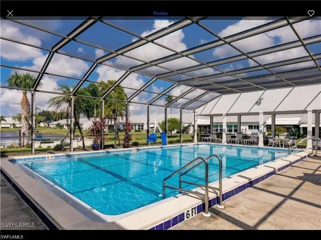 View of swimming pool with a lanai