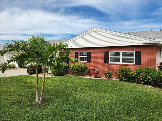 View of side of home featuring a yard