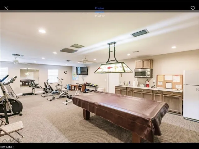 Rec room with light carpet, billiards, and ceiling fan