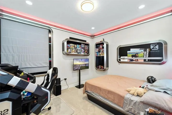 Room featuring wall-mounted shelving, recessed lighting, and a window with a Roman shade