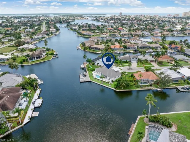 Birds eye view of property with a water view