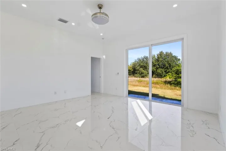Dining room with light marble finish flooring and recessed lighting