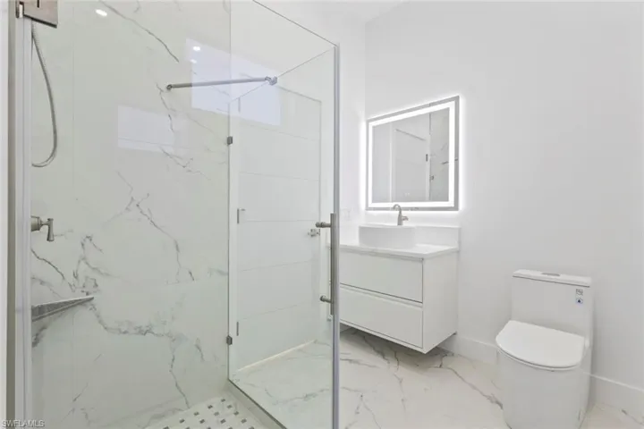 2nd Full Bathroom with vanity, a marble finish shower, and light marble finish floors