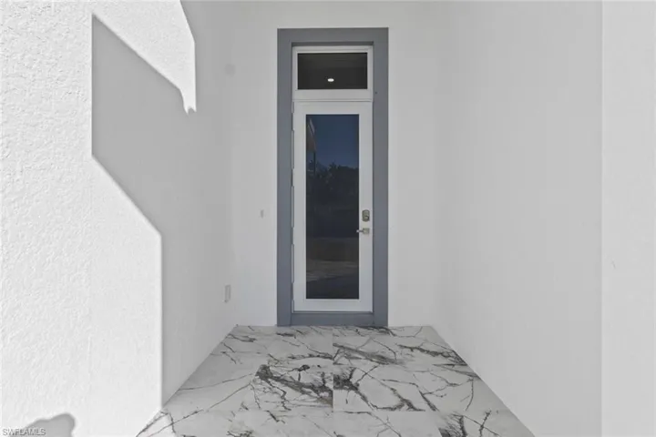 View of exterior entry with stucco siding