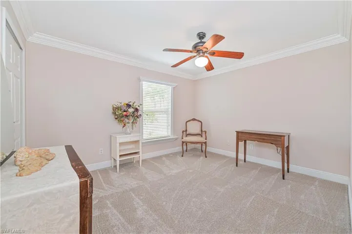 Sitting room featuring ceiling fan, ornamental molding, and light colored carpet