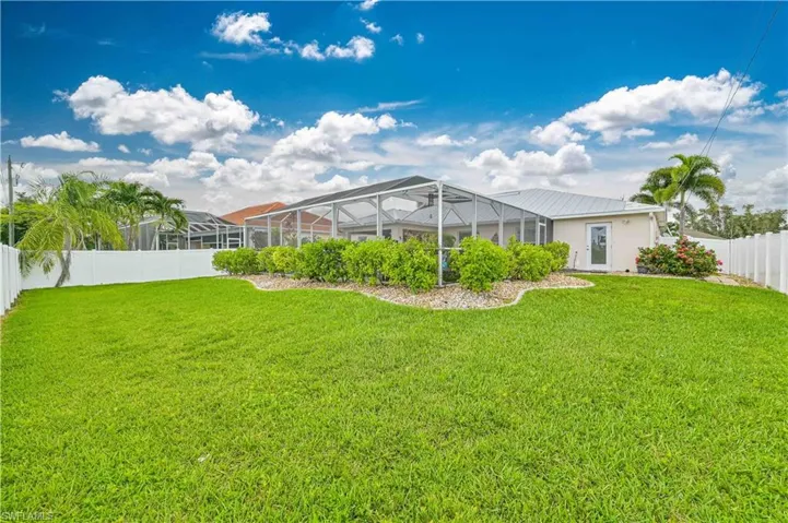 View of yard with glass enclosure