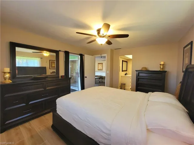 Bedroom featuring light wood-finish flooring and a ceiling fan with integrated lighting