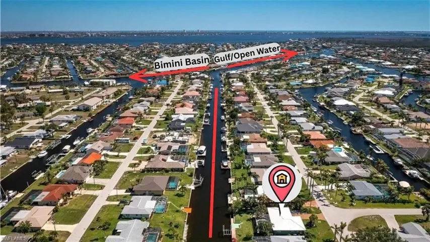 Aerial perspective showcasing a canal-front property with direct water access