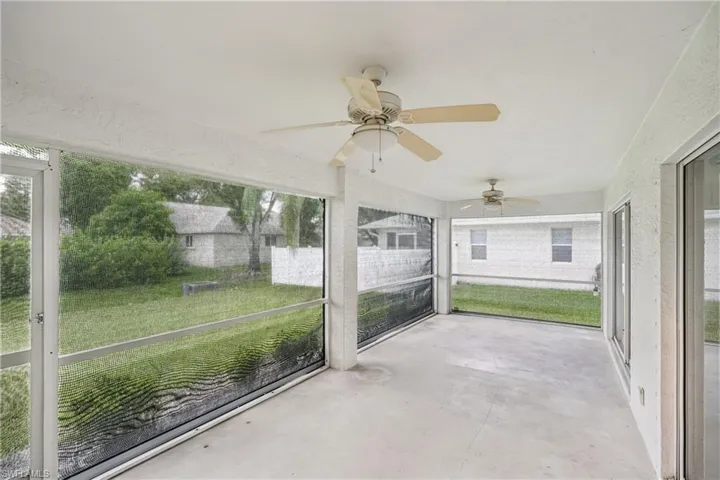 Unfurnished sunroom with ceiling fan