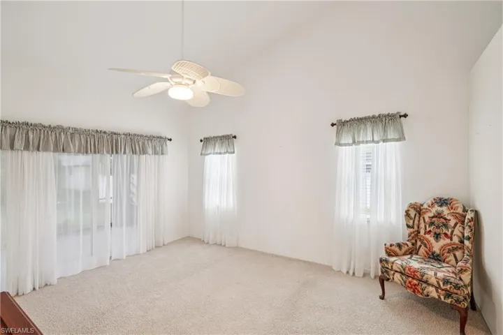 carpet flooring and a ceiling fan