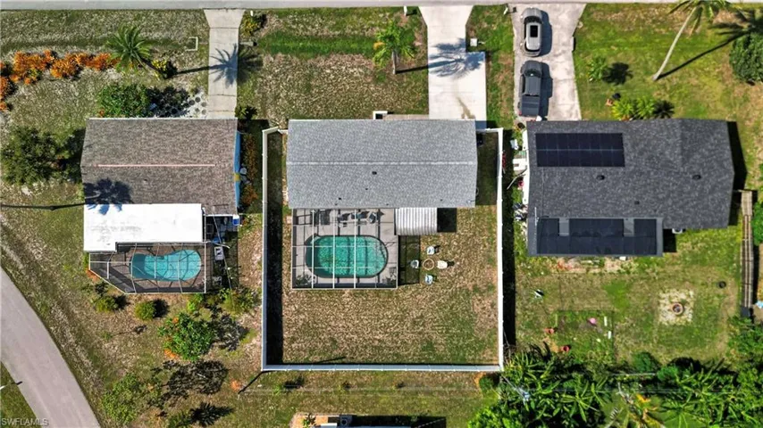 Fenced backyard featuring a screened-in swimming pool and a concrete patio