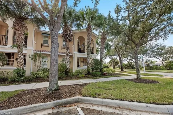 The property features a stucco exterior with multiple balconies and a tile roof