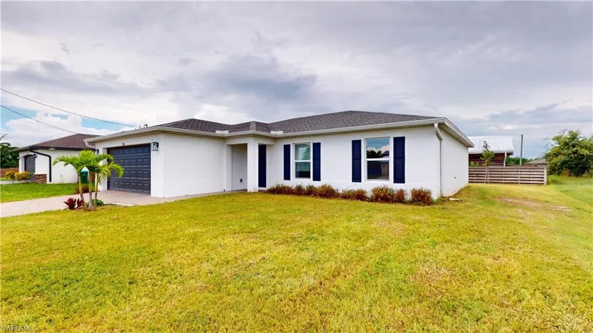 Ranch-style house with a garage and a front yard