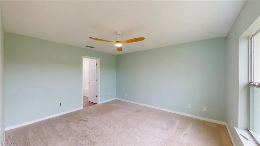 Spare room with ceiling fan and carpet flooring