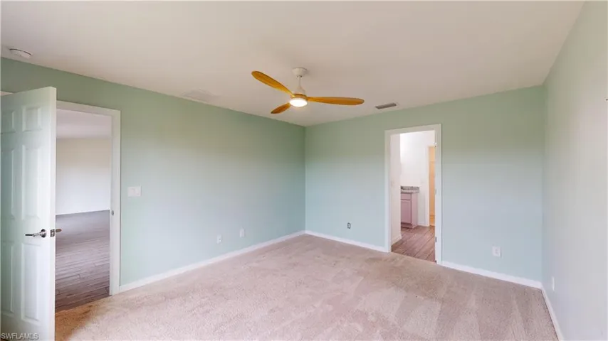 Spare room featuring ceiling fan and carpet