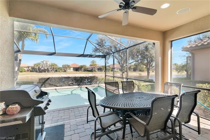 View of patio / terrace with area for grilling, an outdoor pool, a sunroom, a lanai, and outdoor dining area