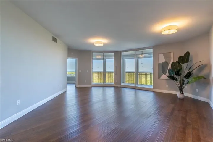 Great room with floor to ceiling sliding glass doors with views over mangrove forest to the Gulf