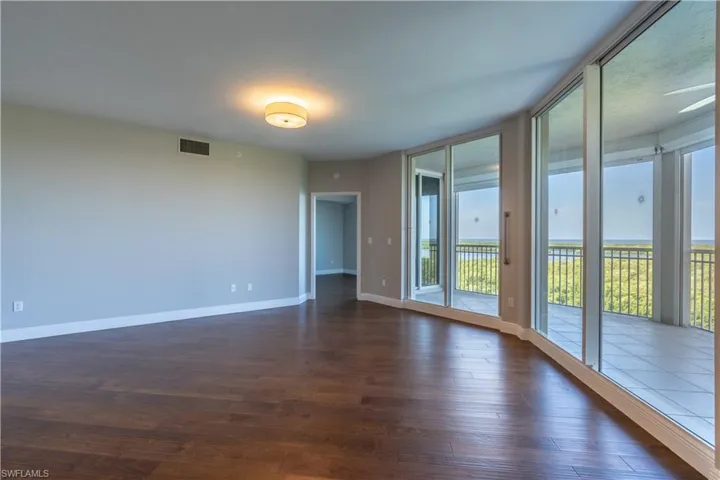 Great room with hardwood flooring and access to lanai overlooking the Gulf