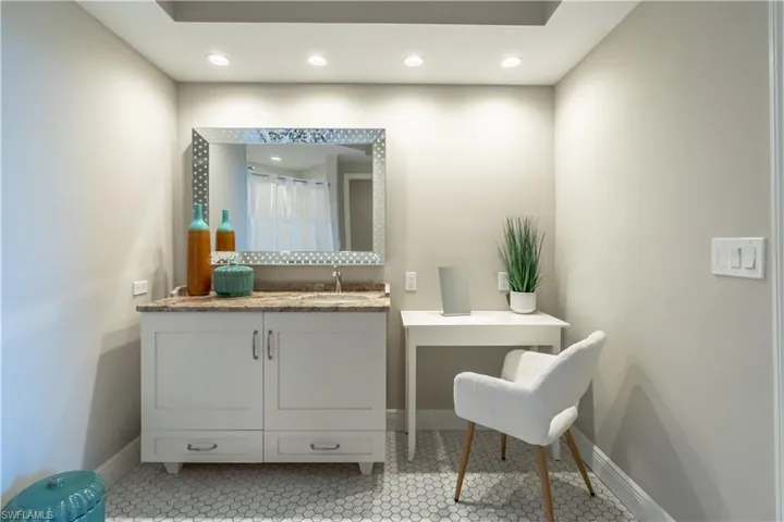 Primary bath with classic tile, vanity and make up table