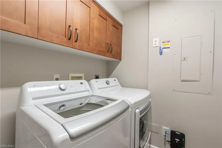 Laundry room with wood storage cabinets