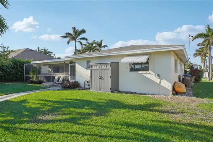 View of front of property featuring a sunroom and a front yard