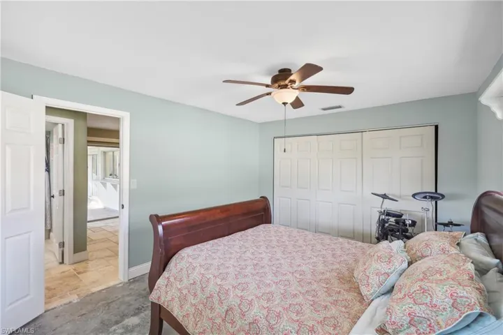 Bedroom featuring ceiling fan and a closet