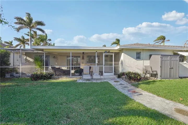 Rear view of property featuring a lawn