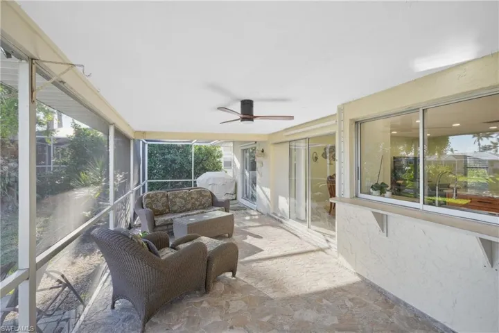 Sunroom / solarium featuring ceiling fan