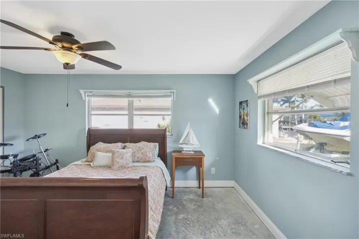 Bedroom with multiple windows and ceiling fan