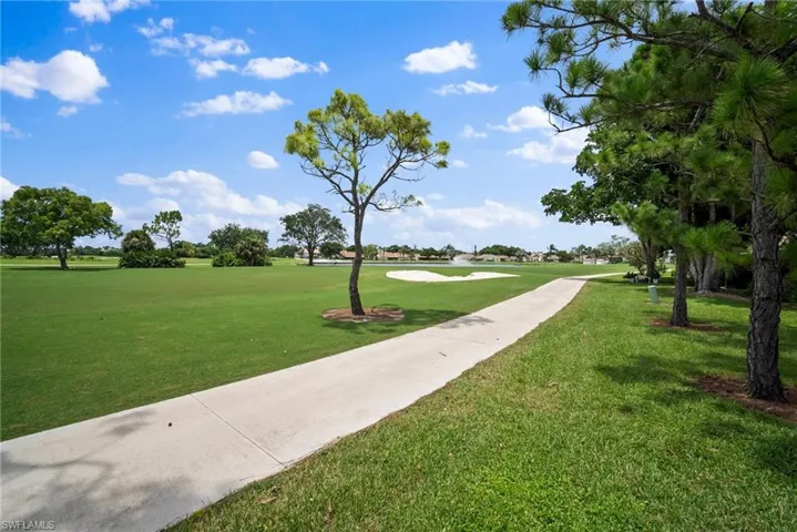 View of home's community with a lawn