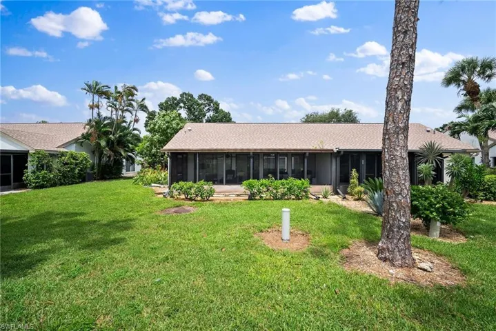 View of front of house featuring a sunroom and a front lawn