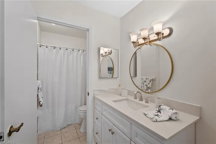 Bathroom featuring vanity, toilet, and tile patterned floors
