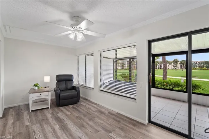Living area featuring light hardwood / wood-style floors, a textured ceiling, and ceiling fan